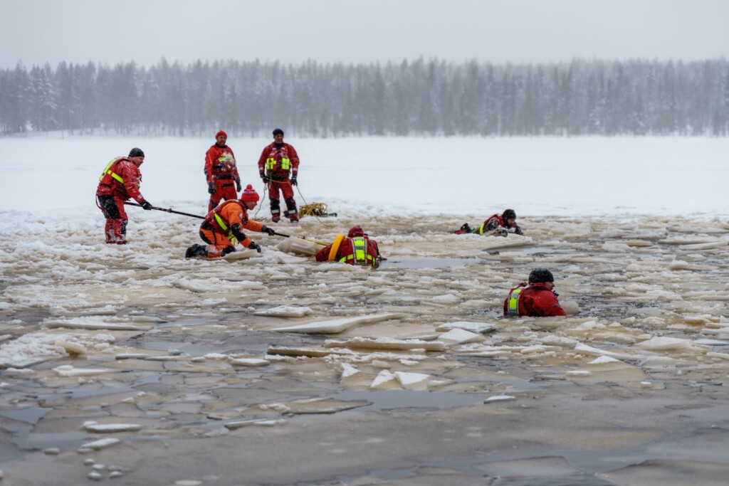 People in the ice and water with safety gear
